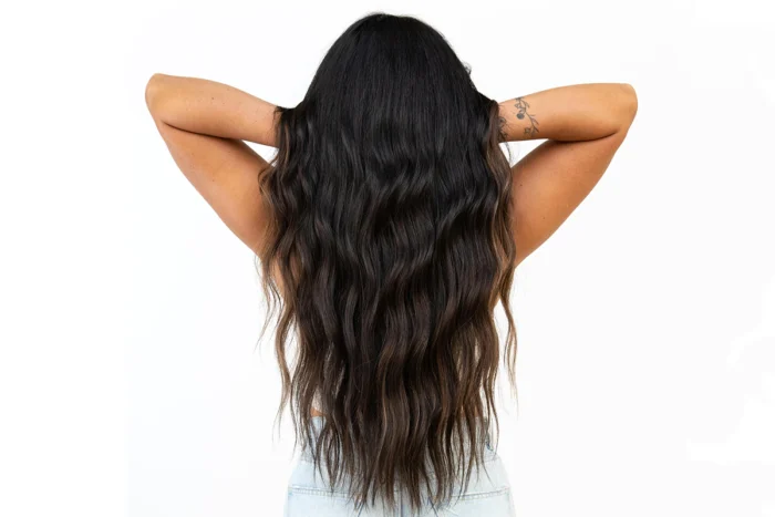 Woman showing off her healthy hair extensions